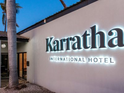 The illuminated front entry sign to the Karratha International Hotel